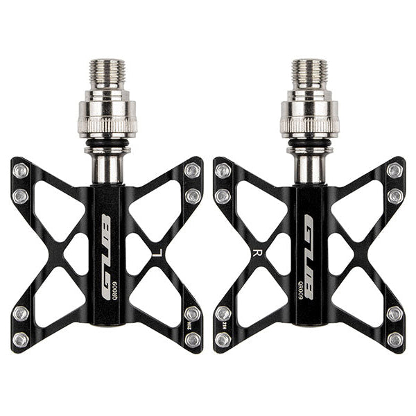 Pair of black bicycle pedals with silver axle on a white background