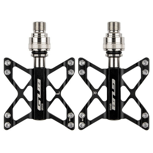 Pair of black bicycle pedals with silver axle on a white background
